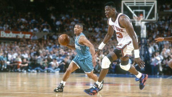 5'3 Muggsy Bogues looks to pass the ball past 7'1 Patrick Ewing during a 1993 playoff game between the Charlotte Hornets and the New York Knicks.